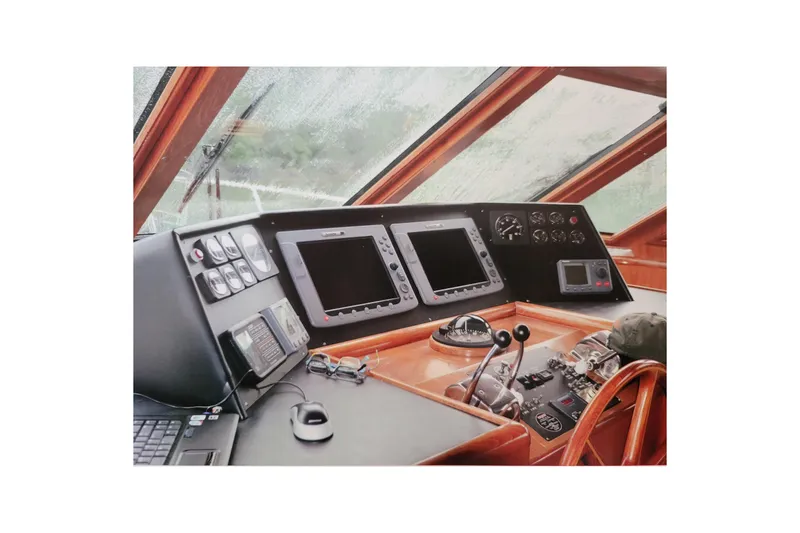 Slide: The Image of Pilothouse interior of 1990 Ocean Alexander 520, featuring navigation equipment and controls. - 24