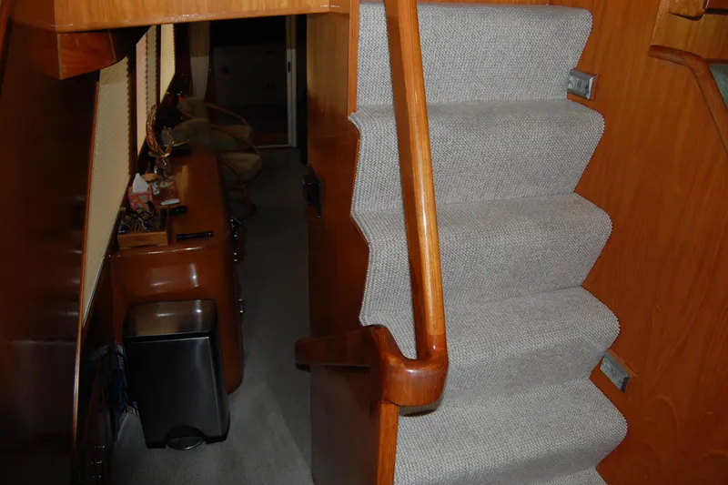 Slide: The Image of Interior stairs of 1990 Ocean Alexander 520 Pilothouse with wooden handrail and carpeted steps. - 31