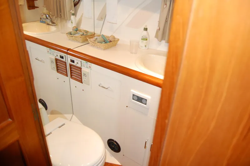 Slide: The Image of Bathroom interior of 1990 Ocean Alexander 520 Pilothouse yacht, featuring sink and toilet. - 33