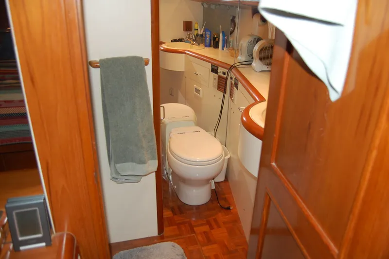 Slide: The Image of Bathroom interior of 1990 Ocean Alexander 520 Pilothouse yacht, featuring wooden accents and modern amenities. - 36