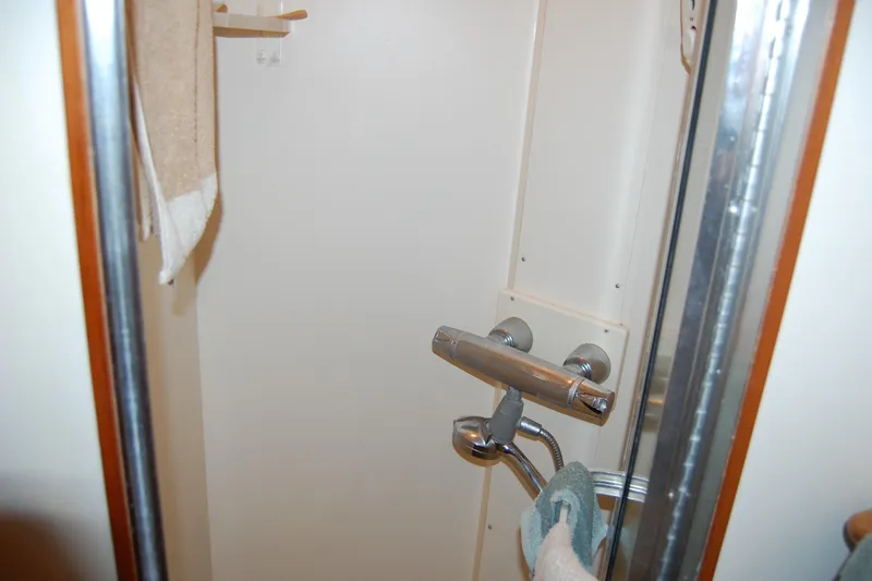 Slide: The Image of Shower area in 1990 Ocean Alexander 520 Pilothouse yacht, featuring chrome fixtures and towel. - 37