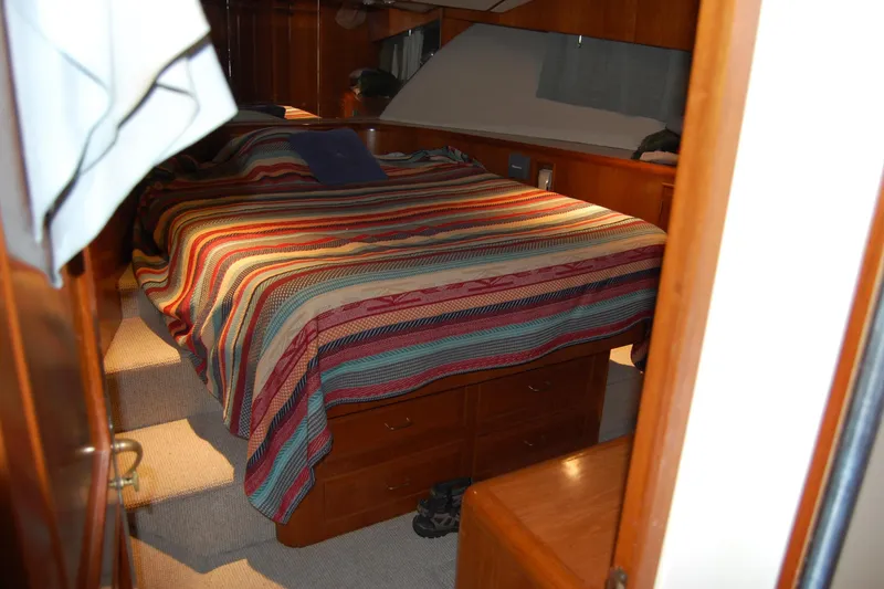 Slide: The Image of Cozy bedroom in 1990 Ocean Alexander 520 Pilothouse yacht with striped bedding. - 38