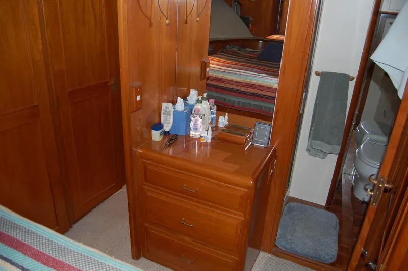 Slide: The Image of 1990 Ocean Alexander 520 Pilothouse interior with wooden cabinetry and bathroom view. - 39