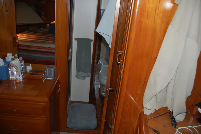 Slide: The Image of Interior of 1990 Ocean Alexander 520 Pilothouse with wooden cabinetry and bathroom view. - 40