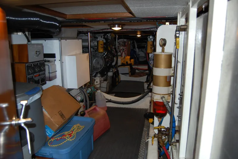 Slide: The Image of Engine room of a 1990 Ocean Alexander 520 Pilothouse, featuring equipment and storage items. - 43
