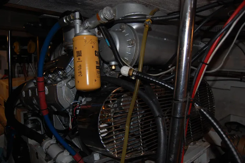 Slide: The Image of Engine room of 1990 Ocean Alexander 520 Pilothouse with visible filter and wiring. - 45