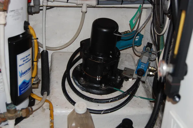 Slide: The Image of Engine room of 1990 Ocean Alexander 520 Pilothouse with mechanical components and wiring. - 46