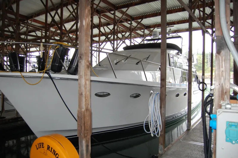 Slide: The Image of 1990 Ocean Alexander 520 Pilothouse yacht docked in a covered marina. - 5
