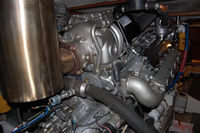 Slide: The Image of Engine room of 1990 Ocean Alexander 520 Pilothouse yacht, showcasing detailed machinery components. - 52