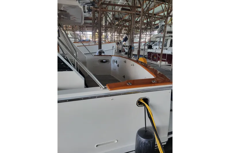 Slide: The Image of 1990 Ocean Alexander 520 Pilothouse yacht docked in a marina, showcasing sleek design. - 55