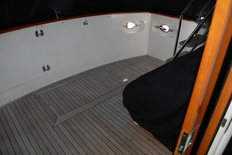 Slide: The Image of 1990 Ocean Alexander 520 Pilothouse deck with wooden flooring and stairs. - 56