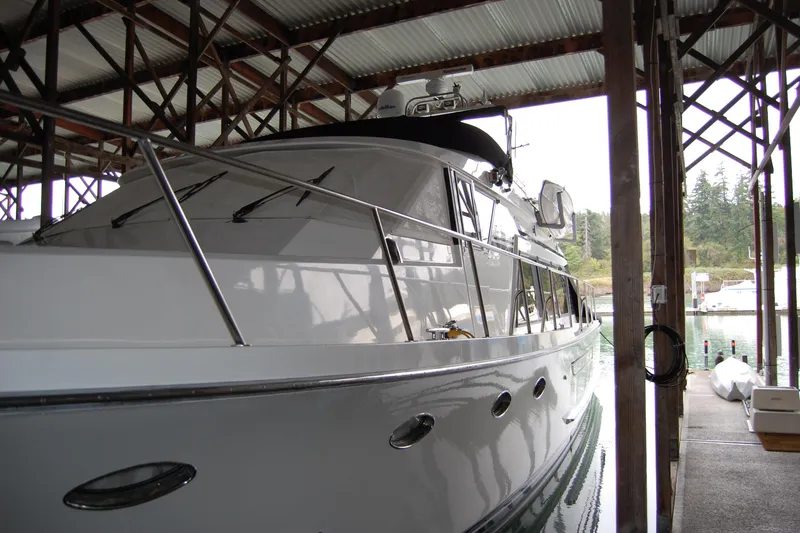 Slide: The Image of 1990 Ocean Alexander 520 Pilothouse yacht docked in a covered marina. - 6
