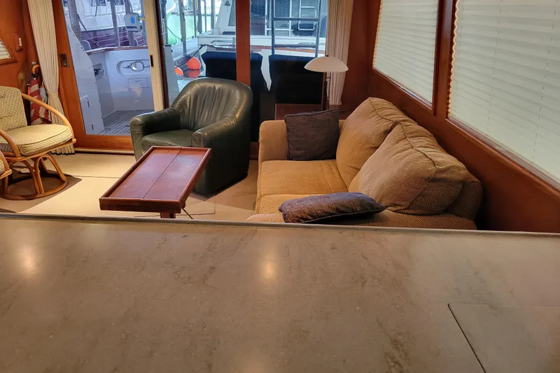 Slide: The Image of Interior of 1990 Ocean Alexander 520 Pilothouse with cozy seating and wooden accents. - 62