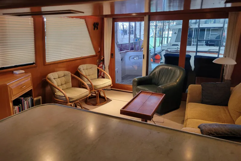 Slide: The Image of Interior of 1990 Ocean Alexander 520 Pilothouse with cozy seating and large windows. - 63