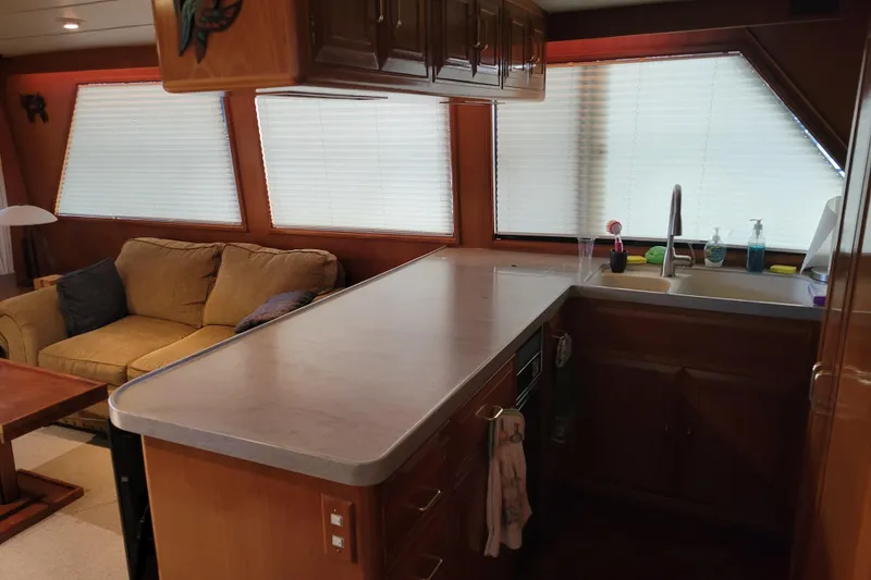 Slide: The Image of Interior of 1990 Ocean Alexander 520 Pilothouse with kitchen and cozy seating area. - 66