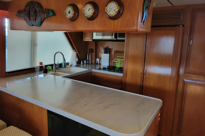 Slide: The Image of Interior of 1990 Ocean Alexander 520 Pilothouse with wooden cabinetry and modern kitchen amenities. - 67