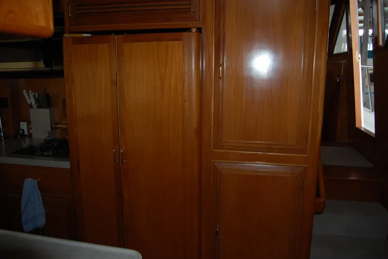 Slide: The Image of Interior of 1990 Ocean Alexander 520 Pilothouse with wooden cabinetry and kitchen area. - 68