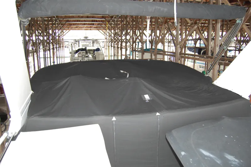 Slide: The Image of Covered 1990 Ocean Alexander 520 Pilothouse yacht in a wooden boathouse. - 74