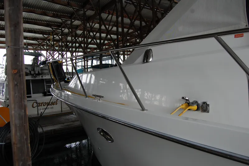 Slide: The Image of 1990 Ocean Alexander 520 Pilothouse yacht docked in a covered marina. - 8