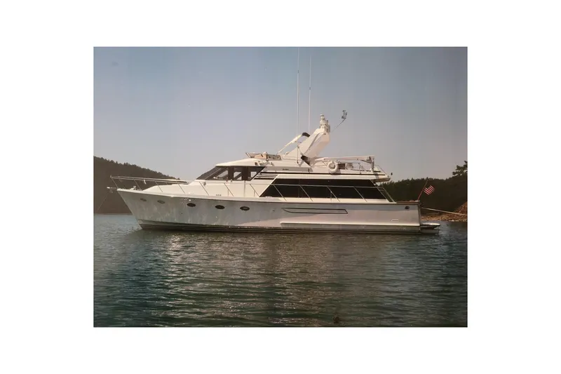 Slide: The Image of 1990 Ocean Alexander 520 Pilothouse yacht on calm water, side view. - 80