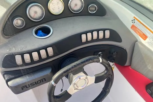 Slide: The Image of 2012 Rinker Captiva 216 BR boat dashboard with steering wheel and control panel. - 2