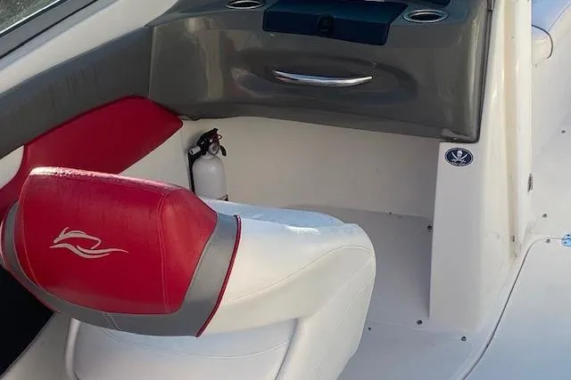 Slide: The Image of 2012 Rinker Captiva 216 BR boat interior with red and white seating and dashboard. - 5