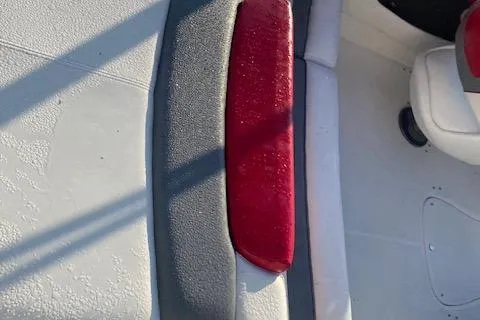 Slide: The Image of 2012 Rinker Captiva 216 BR boat interior with red and gray seating. - 7