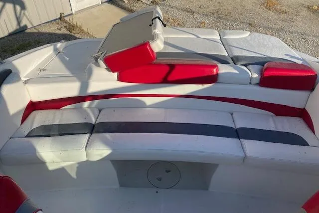 Slide: The Image of 2012 Rinker Captiva 216 BR boat interior with red and white seating. - 8