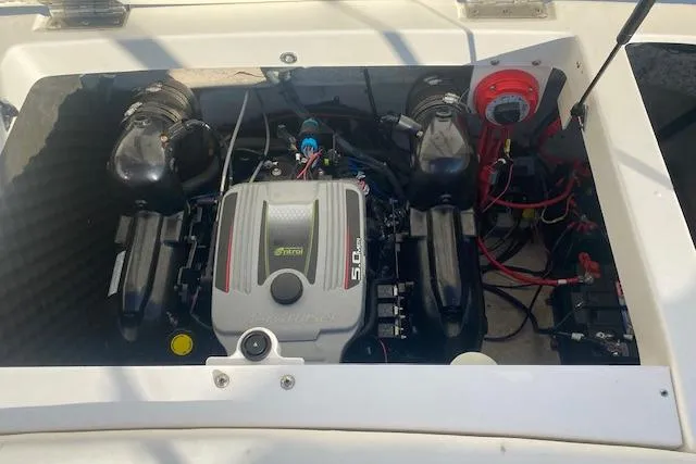 Slide: The Image of 2012 Rinker Captiva 216 BR engine compartment with 5.0L motor and wiring. - 9