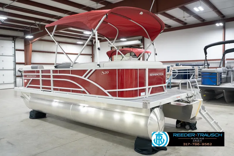 Slide: The Image of 2026 Bennington 20 SL pontoon boat with red canopy in a showroom. - 10