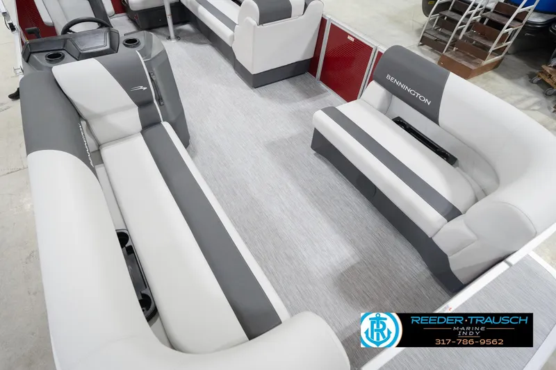 Slide: The Image of 2026 Bennington 20 SL pontoon boat interior with gray and white seating, showcased at Reeder-Trausch Marine. - 13