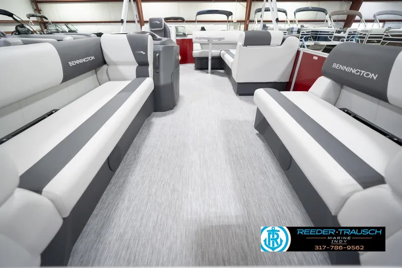 Slide: The Image of 2026 Bennington 20 SL pontoon boat interior with gray and white seating, showcased at Reeder-Trausch Marine. - 16