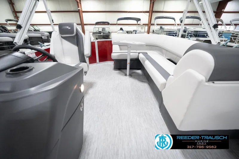 Slide: The Image of 2026 Bennington 20 SL pontoon boat interior with modern seating and steering console. - 17