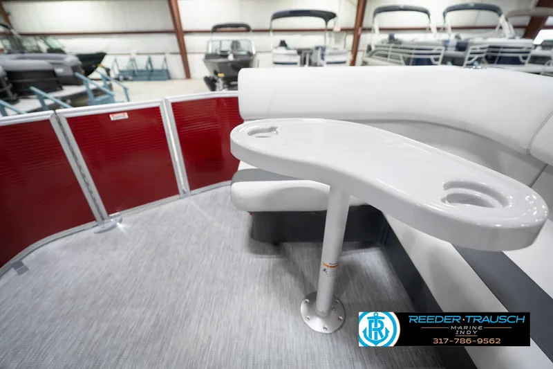 Slide: The Image of 2026 Bennington 20 SL pontoon boat interior with seating and table, showcased at Reeder Trausch Marine. - 18