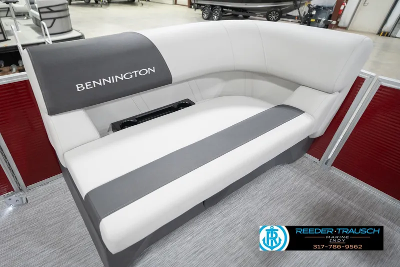 Slide: The Image of 2026 Bennington 20 SL boat interior with white and gray seating in showroom. - 22