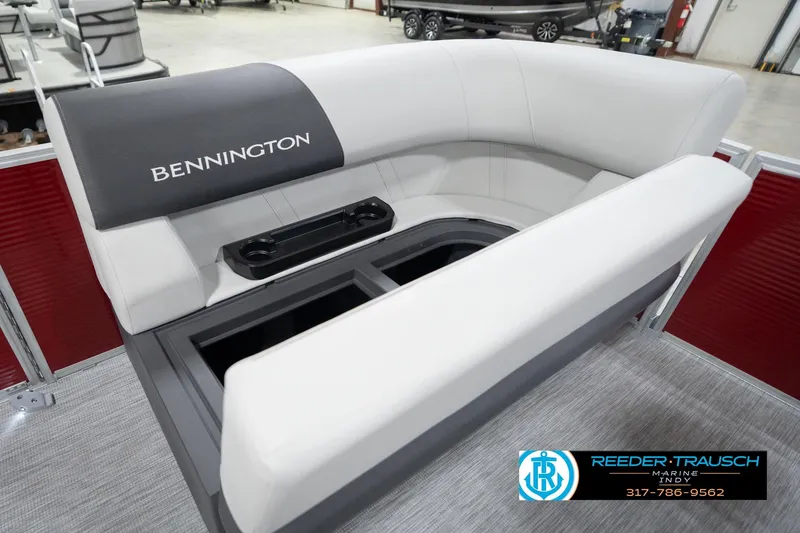 Slide: The Image of 2026 Bennington 20 SL boat interior with white seating and storage compartment. - 23