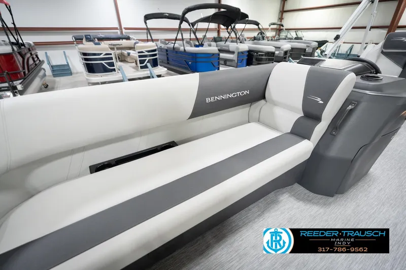 Slide: The Image of 2026 Bennington 20 SL pontoon boat interior with gray and white seating in showroom. - 24