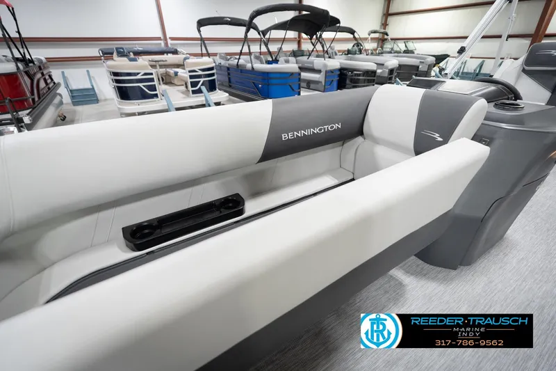 Slide: The Image of 2026 Bennington 20 SL pontoon boat interior with sleek seating in showroom. - 25
