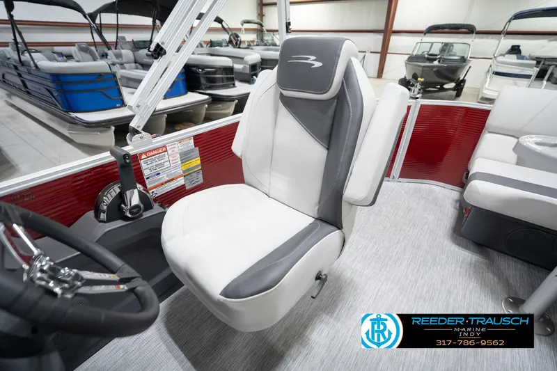 Slide: The Image of 2026 Bennington 20 SL boat interior with white and gray seating in showroom. - 26