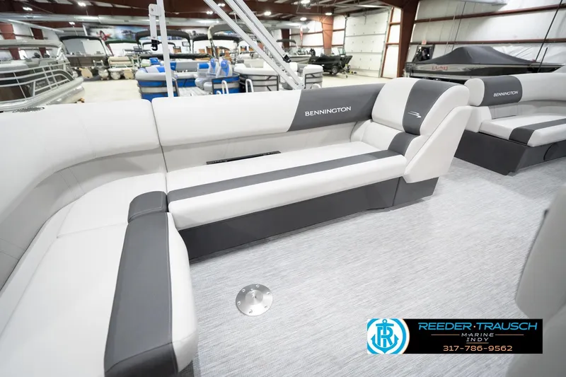 Slide: The Image of 2026 Bennington 20 SL pontoon boat interior with sleek seating in showroom. - 29