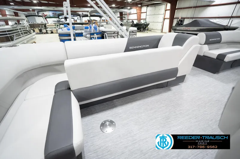 Slide: The Image of 2026 Bennington 20 SL pontoon boat interior with gray and white seating in showroom. - 31