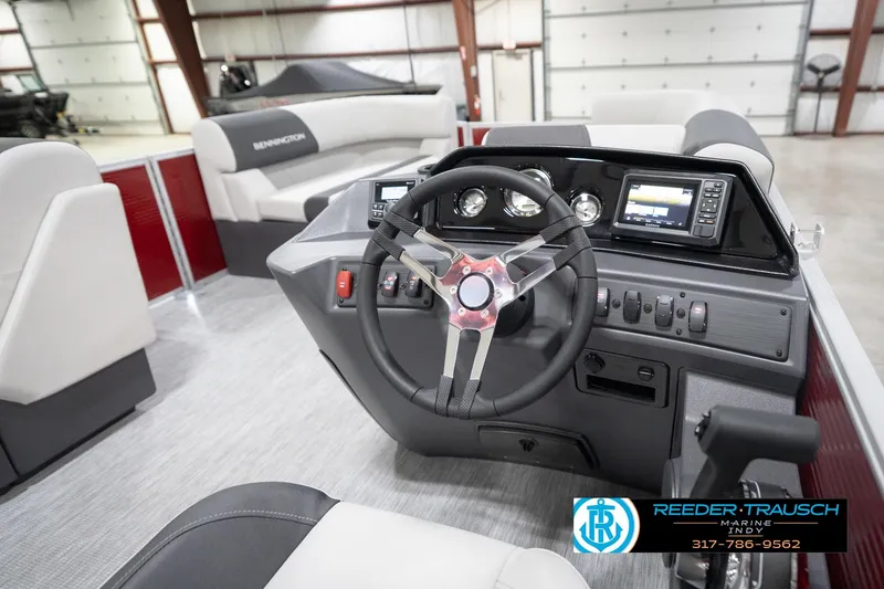 Slide: The Image of 2026 Bennington 20 SL boat interior with steering wheel and dashboard controls. - 33