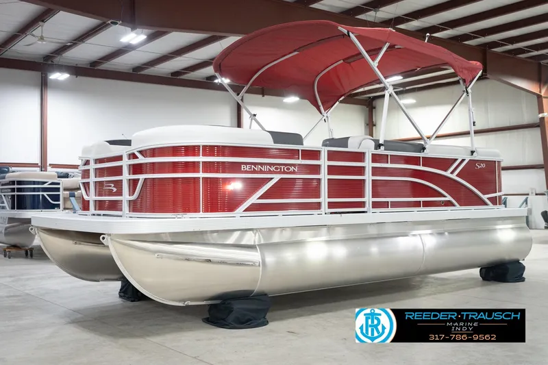 Slide: The Image of 2026 Bennington 20 SL pontoon boat with red canopy in showroom. - 4