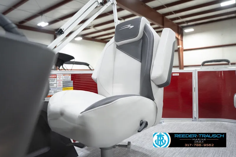 Slide: The Image of 2026 Bennington 20 SL boat seat in showroom with red paneling and logo. - 42