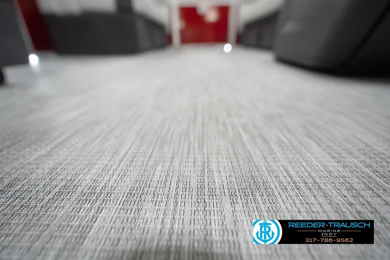 Slide: The Image of Carpet flooring inside a 2026 Bennington 20 SL boat, featuring Reeder-Trausch Marine branding. - 48