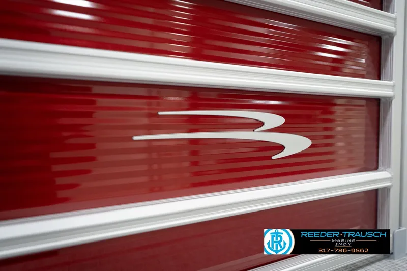 Slide: The Image of Red Bennington 20 SL 2026 boat panel with logo and Reeder-Trausch Marine contact details. - 49