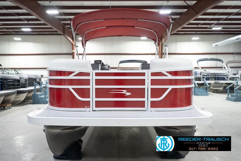 Slide: The Image of 2026 Bennington 20 SL pontoon boat with red exterior in a showroom. - 5