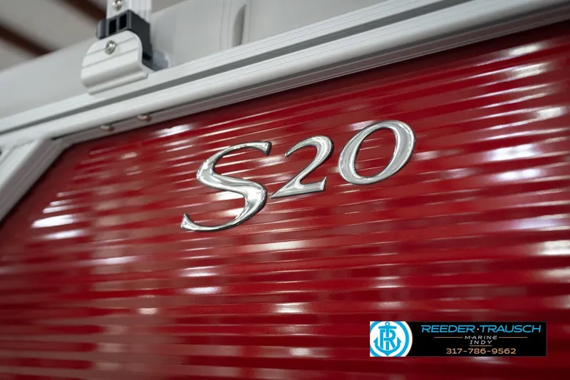 Slide: The Image of 2026 Bennington 20 SL boat with red paneling and S20 emblem, Reeder-Trausch Marine logo. - 57