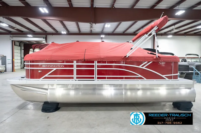 Slide: The Image of 2026 Bennington 20 SL pontoon boat with red cover in a showroom. - 59