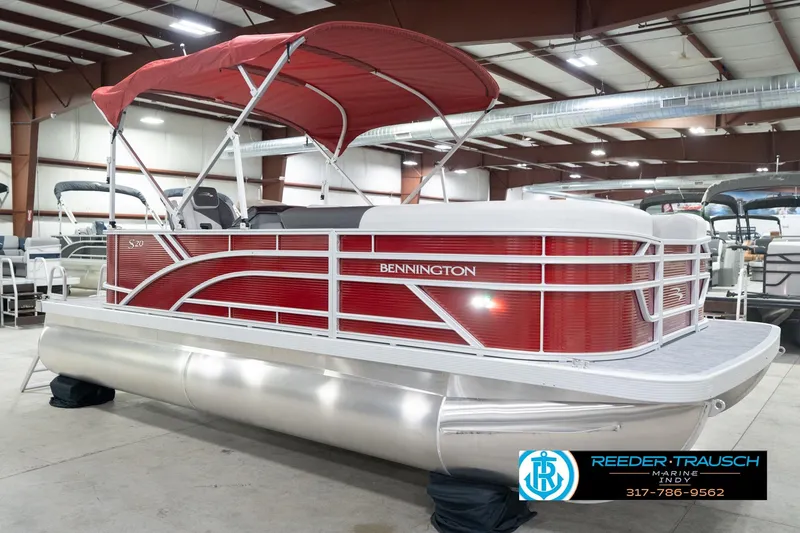 Slide: The Image of 2026 Bennington 20 SL pontoon boat with red canopy in showroom. - 6